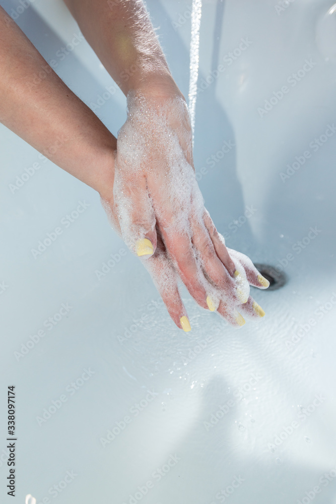 Fototapeta premium Coronavirus pandemic prevention wash hands with soap warm water