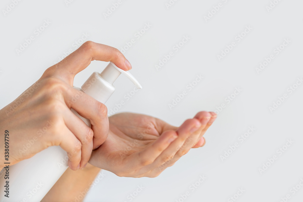 Female person woman or girl applying soap disinfectant product on hand disinfecting hands against virus bacteria health prevention Female person woman or girl applying soap disinfectant product on hand disinfecting hands against virus bacteria health prevention