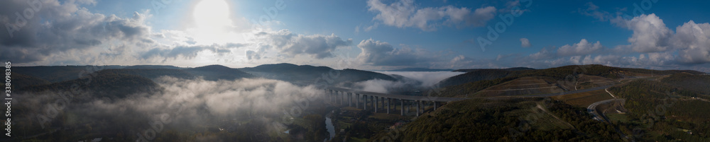 a mystical highway viaduct immersed in fog