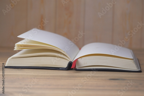 Close up of open boon on wooden table .