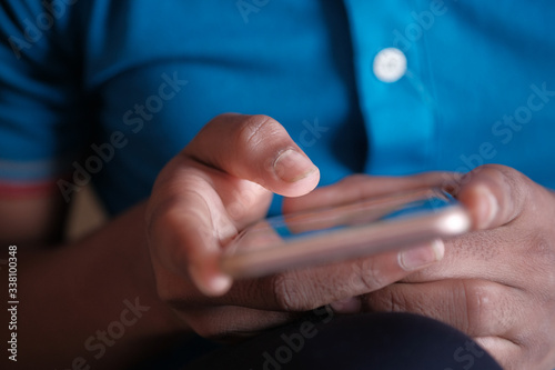 Close up of a young man using mobile smart phone