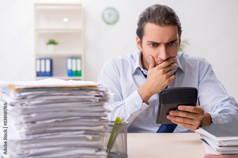 Young male businessman employee unhappy with excessive work