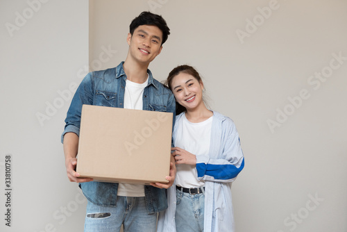 A young asian couple is moving to a new home