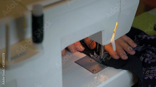 Clothier. Sewing on a typewriter, mending.