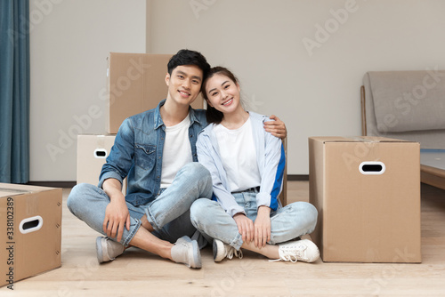 A young asian couple is moving to a new home