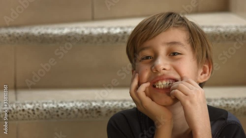 Naughty boy, shows his tooth about to fall out, showing loose tooth
