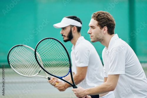 Side view of serious concentrated tennis players with rackets ready to play © DragonImages
