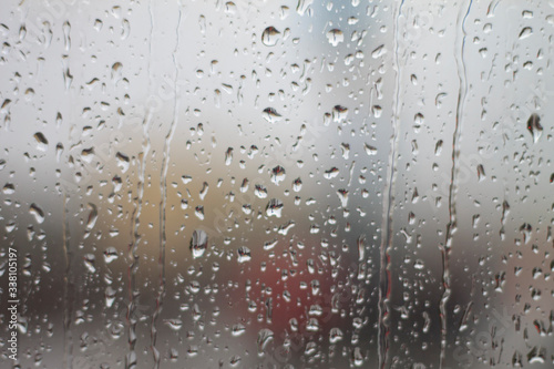 Raindrops on the windowpane. Autumn background.