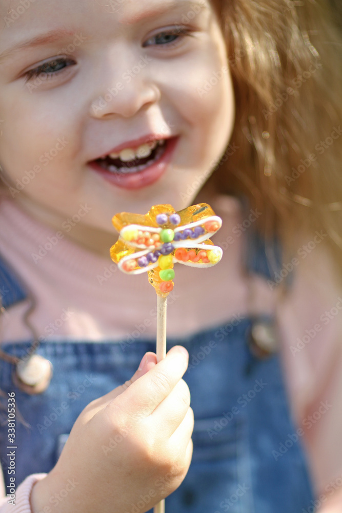 Smiling girl with a Lollipop. Happy girl eat a lollipop. Smiling girl with a Lollipop. Happy girl eat a lollipop.