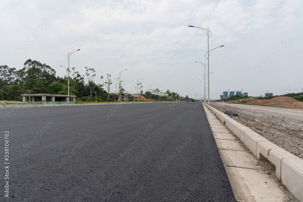 Low angle perspective view of new asphalt road