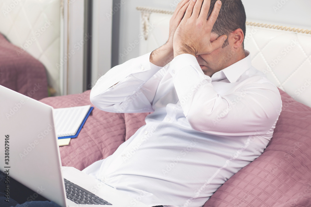 Young tired businessman rubs his eye Young tired businessman rubs his eye