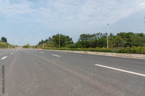 Low angle perspective view of wide asphalt road street