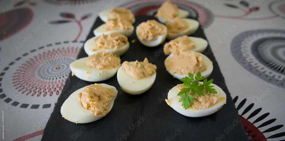 Halved eggs filled with tuna and aromatic herbs. Halved eggs filled with tuna and aromatic herbs.