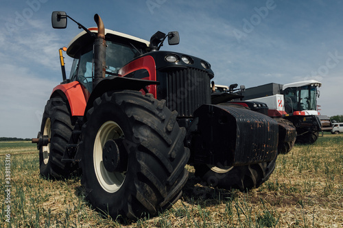 red tractor with large wheels in the field during tests during the exhibition