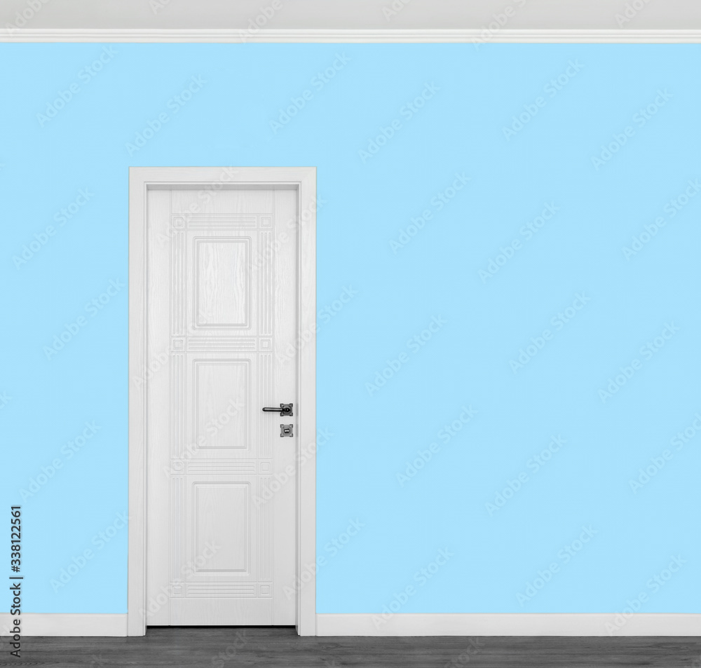 Beautiful wooden white door on empty blue wall with copy space for your text.