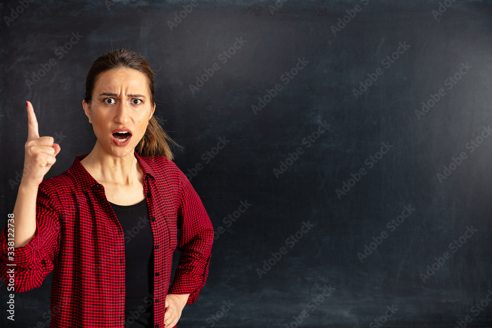 Young woman teacher displeased in classroom. Young woman teacher displeased in classroom.
