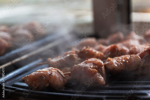 Skewers on skewers from raw meat of pork and beef, chicken cooked on a home electric grill. Top view. Selective focus. Blur photo