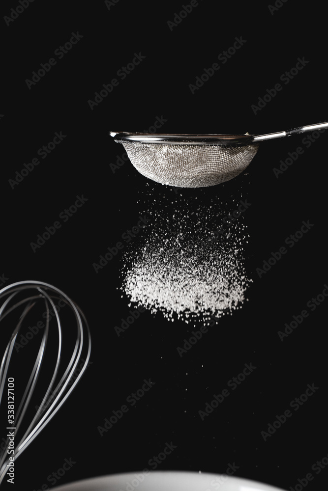 Sifting flour through a sieve Sifting flour through a sieve