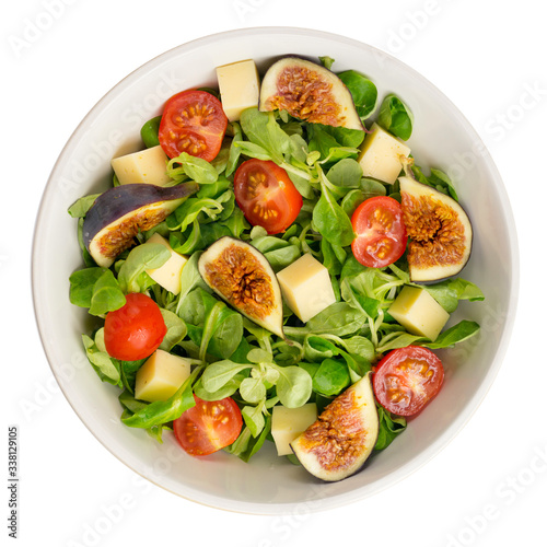 Fresh salad with figs, leaves, cherry tomatoes and cheese on white background. Food concept. Top view.