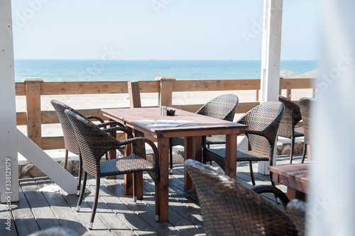 Summer terrace cafe with sea view. Tables and chairs on the summer terrace. © Kyrylo