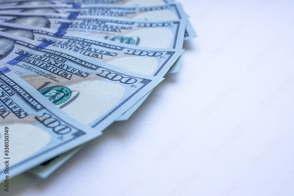 One hundred dollar bills on white background