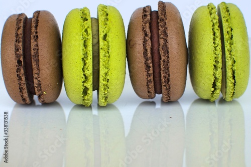 pistachio and chocolate flavor macarooon on white background photo