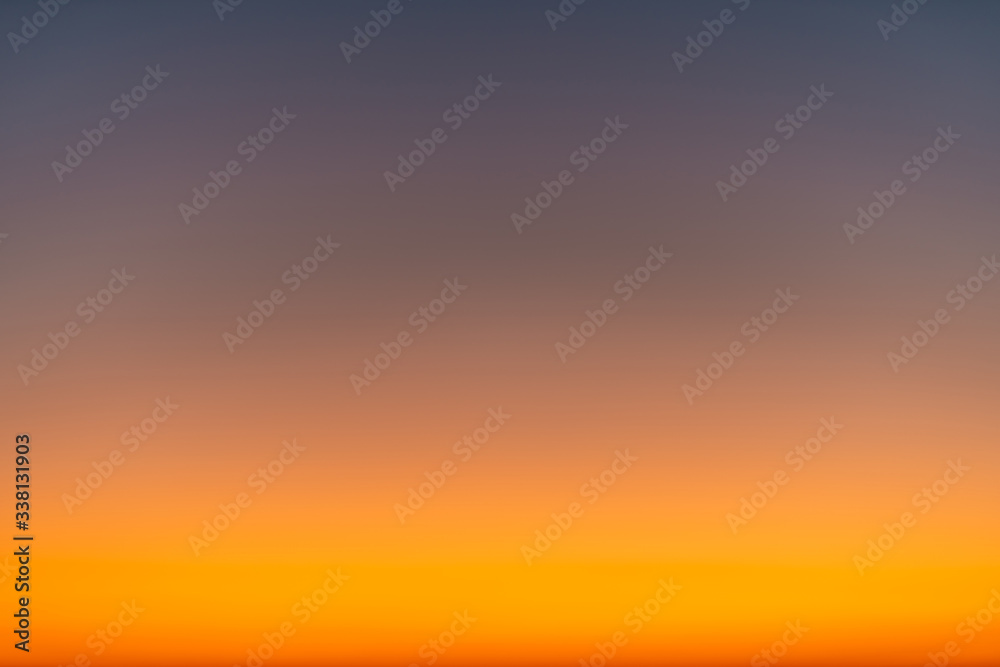 Orange horizon and blue atmosphere. Smooth orange blue gradient of dawn sky.