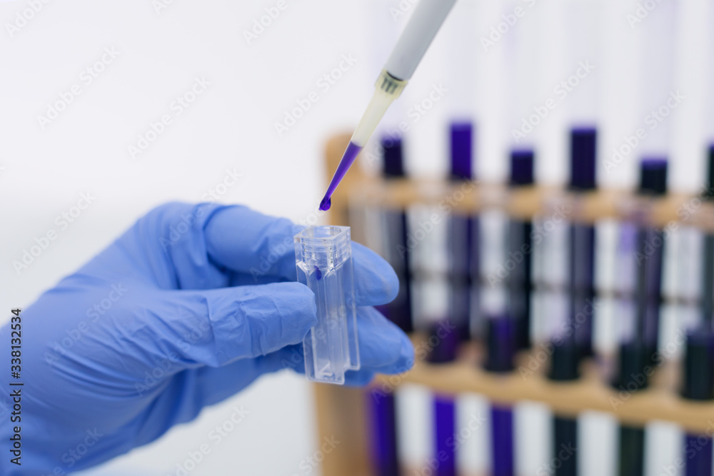 Young female Laboratory scientist working at lab with test tubes, test or research in clinical laboratory.Science, chemistry, biology, medicine and people concept. Young female Laboratory scientist working at lab with test tubes, test or research in clinical laboratory.Science, chemistry, biology, medicine and people concept.