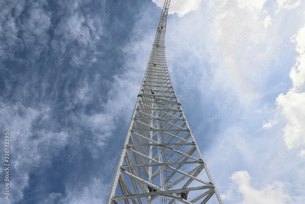 Steel tower set against cloudy blue sky