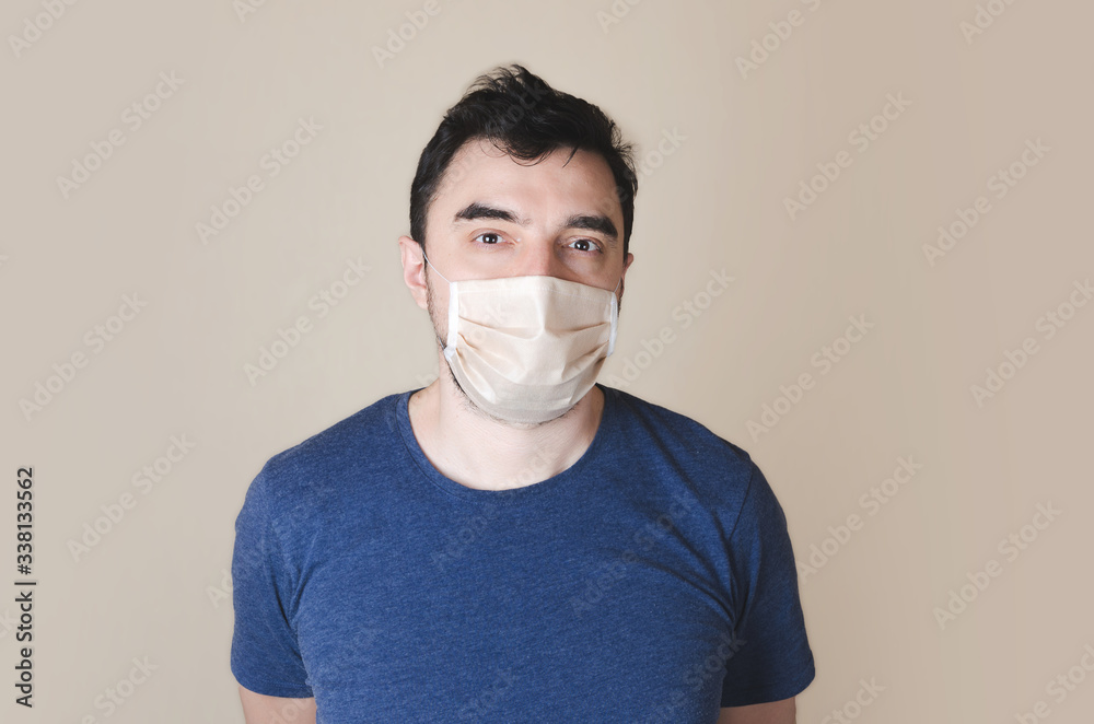 young man wearing a protective mask on light background young man wearing a protective mask on light background