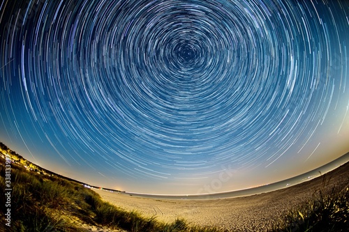 star trails over the nightly beach