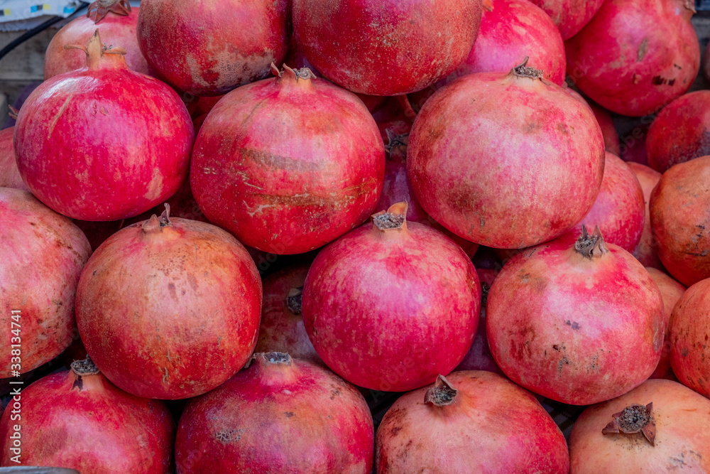 Red pomegranate in a box. Selling crops on the market. Natural, healthy, vitamin-rich foods. Food for health. Red pomegranate in a box. Selling crops on the market. Natural, healthy, vitamin-rich foods. Food for health.