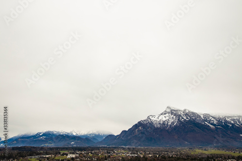 Alps mountain landscape moody scenic view weather snowy winter peaks and gray sky background nature photography in autumn day