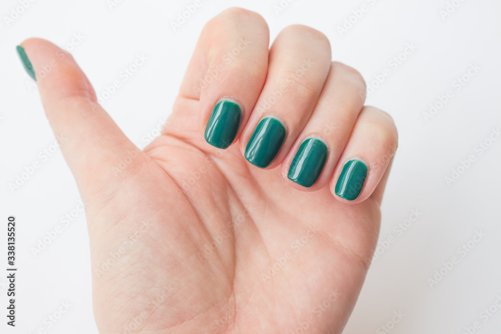 beautiful dark green nail polish female manicure. spa concept, minimalism. Top view beautiful dark green nail polish female manicure. spa concept, minimalism. Top view