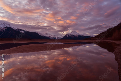Still Waters in the Chilkat Valley - The Chilkat Mountain Range at sunset is reflected in the still pools of water in the Chilkat Valley. Haines Highway, Haines, Alaska. © richardseeley