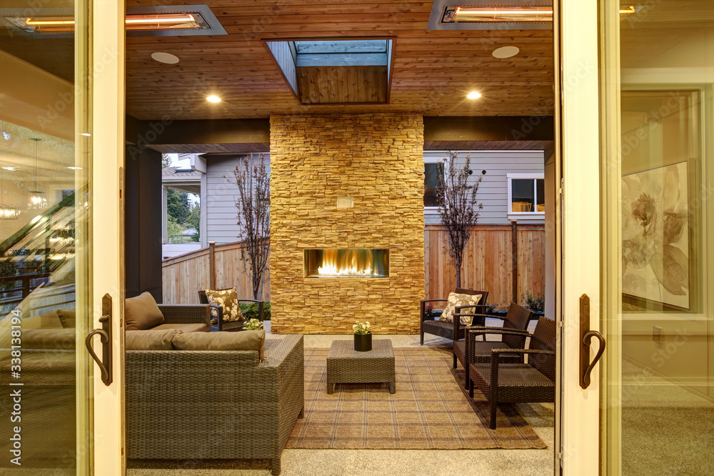 Dreamy outdoor covered patio with stone fireplace