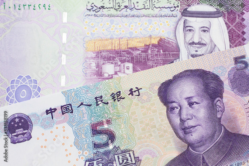 A close up image of a five riyal note from Saudi Arabia along with a five yuan bank note from the People's Republic of China