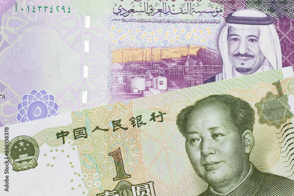 A close up image of a five riyal note from Saudi Arabia along with a one yuan bank note from the People's Republic of China