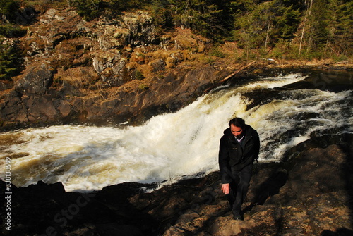 Man in Kivach Falls is high cascade waterfall in Russia. It is located on Suna River in Kondopoga District, Republic of Karelia and gives its name to the Kivach Natural Reserve photo