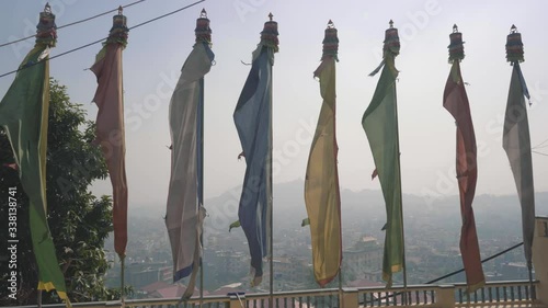 Colorful Flags Waving In The Air In Front Of Triten Norbutse Monastery In Kathmandu, Nepal  - Beautiful Tourist Attraction - Panning Shot photo