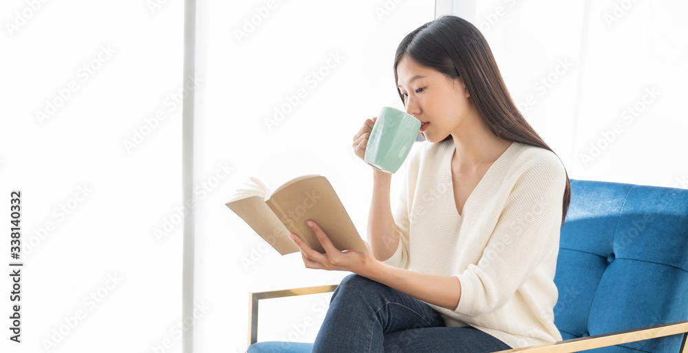 Portrait Asian woman reading book and relaxing with coffee at home Portrait Asian woman reading book and relaxing with coffee at home