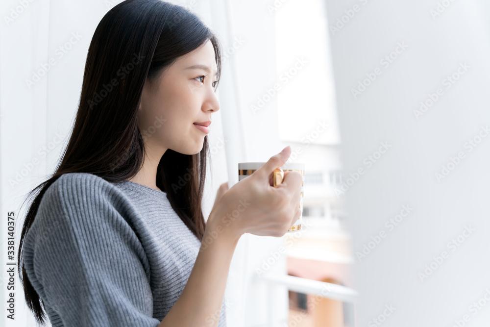 Portrait Asian beauty woman relaxing with coffee at home .Girl and coffee tea in the morning at window. Portrait Asian beauty woman relaxing with coffee at home .Girl and coffee tea in the morning at window.