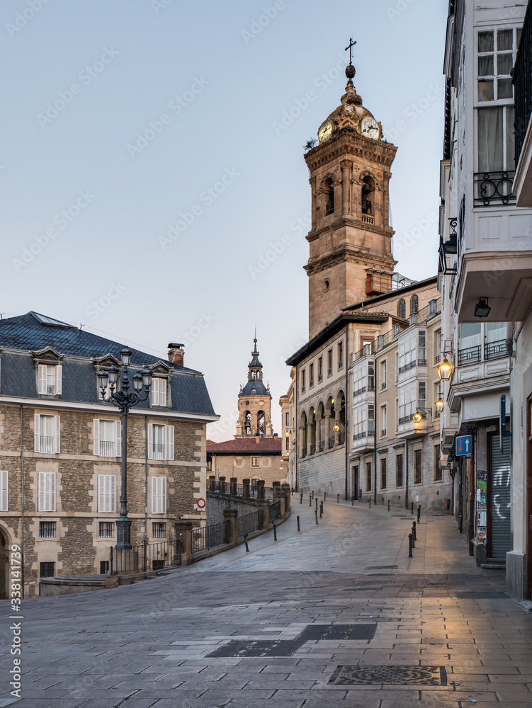 View of the tower of St. Vincent Church and Cuesta de San Vicente Street, in the back the tower of St. Michael Church in Vitoria-Gasteiz, Spain