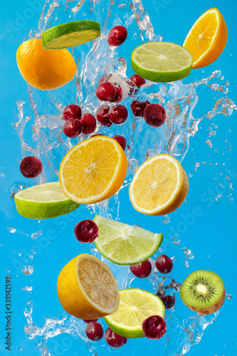 Slices of the lemon  orange  lime  kiwi and cherry with fresh water in the air