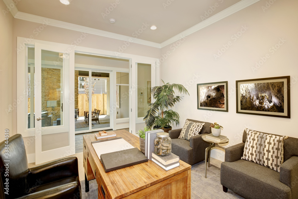 Fototapeta premium Light home office features a wooden desk. Luxury American modern home.