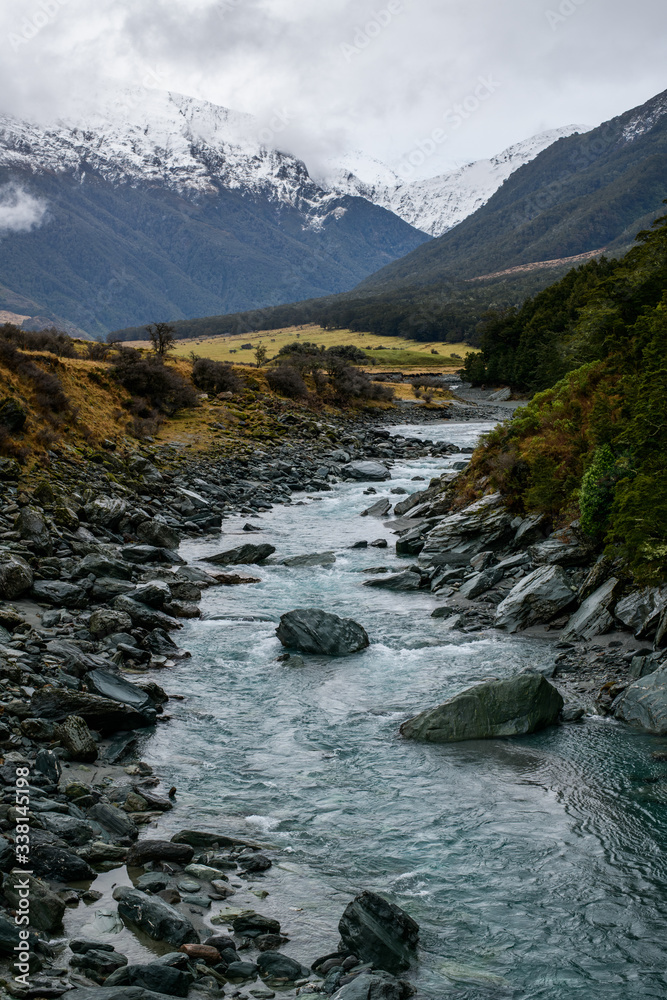 Snow peak with river in south island, Wanaka, New Zealand. Photograph in winter 2019.