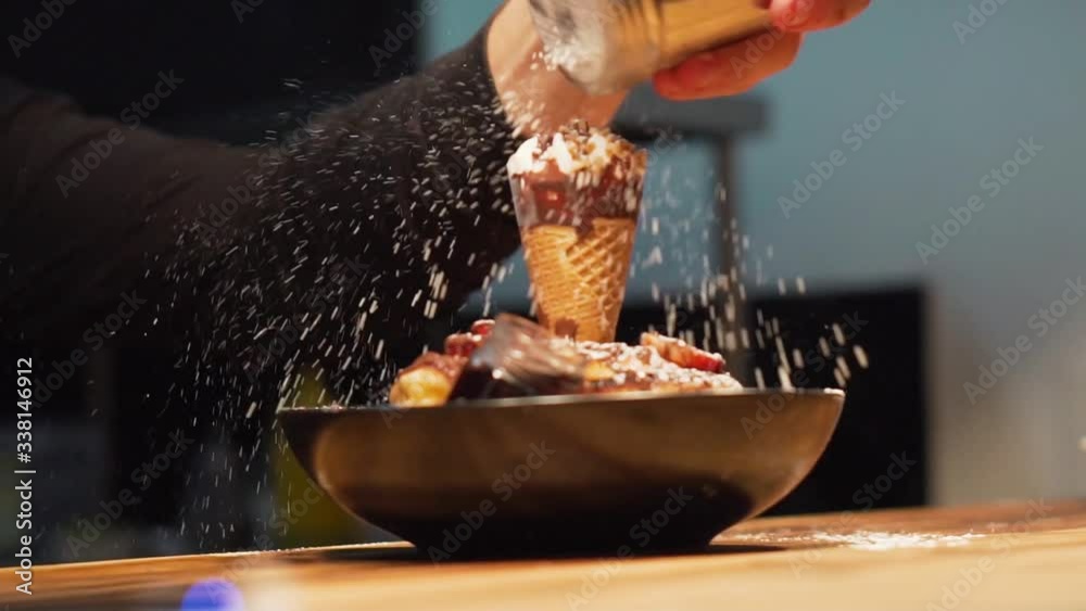 chef sprinkling sugar on luxury pancake breakfast