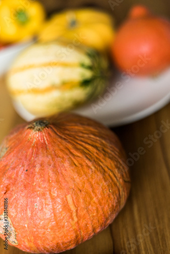 Autumn little pumpkins on a wooden table.