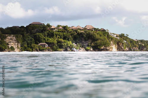 View of houses on rocky coastline by sea