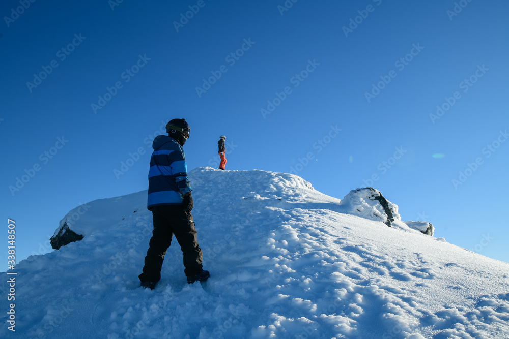 Travellers hiking to the top of snow mountain in south island, New Zealand.